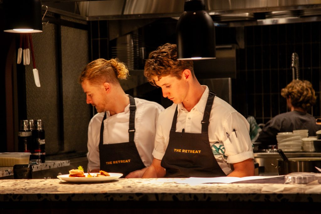 Geelong's newest French-inspired restaurant - The Retreat restaurant and bar. Two chefs working in the kitchen. 