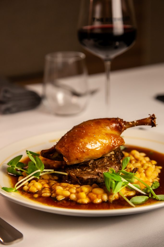 Geelong's newest French-inspired restaurant - The Retreat restaurant and bar. Confit duck leg, contechino sausage, white bean cassoulet, duck jus, pea tendrils.